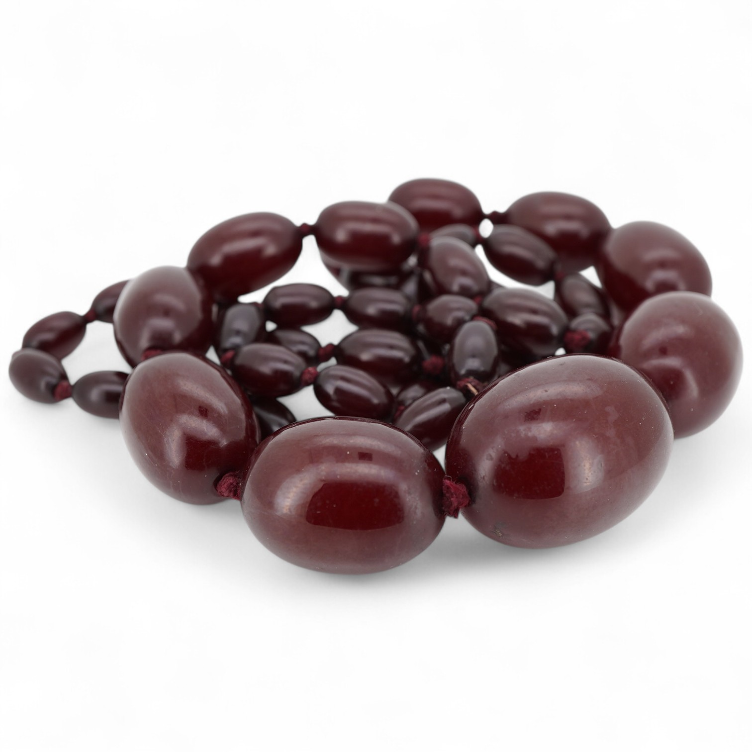A single strand simulated cherry amber bead necklace, with graduated oval beads, 72cm, gross weight 73 grams.